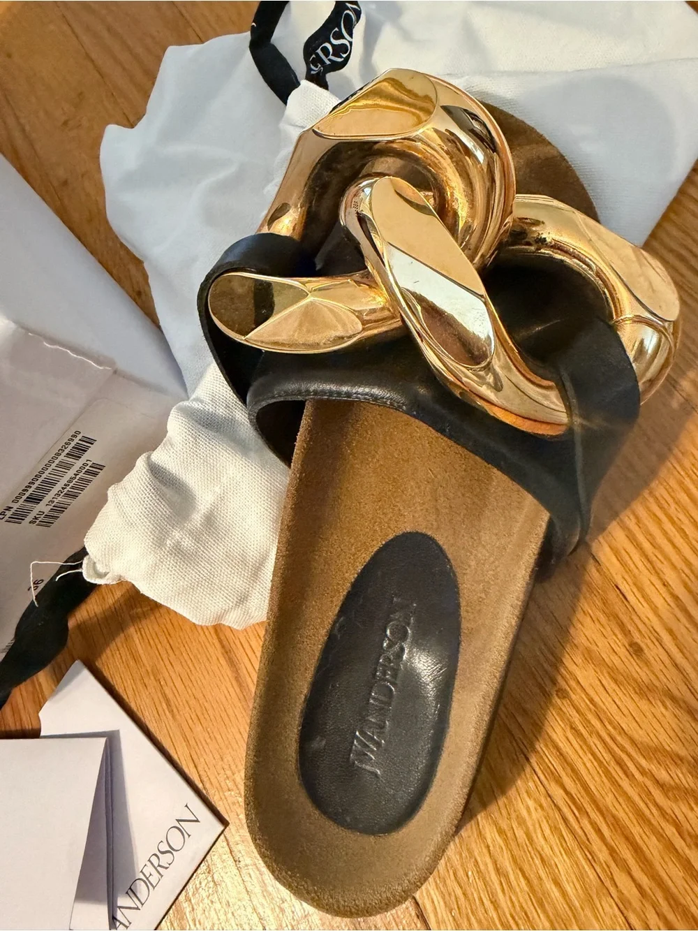 JW Anderson Women’s Black Slide Sandals with Gold Chain Accent